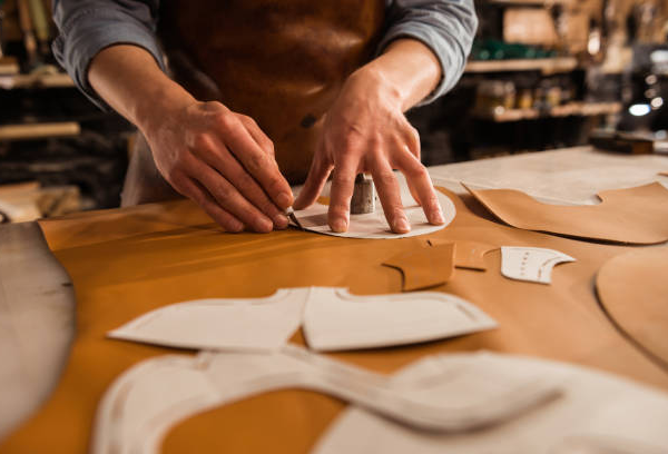 close-up-of-a-male-shoemaker-cutting-leather-textile close-up-of-a-male-shoemaker-cutting-leather-textile